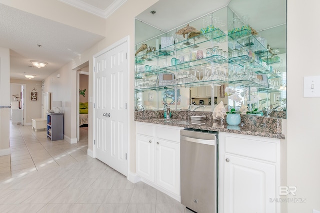 bar featuring white cabinetry, ornamental molding, dark stone countertops, and light tile patterned floors