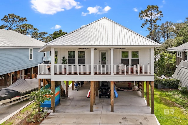 back of house featuring a carport, ceiling fan, and covered porch