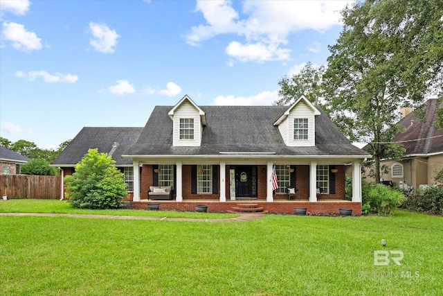 cape cod home featuring a front yard and a porch