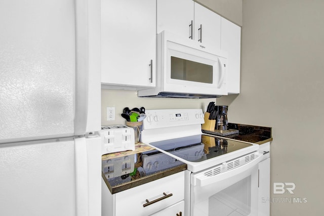 24568 Perdido Beach Blvd Unit 603, Orange Beach, AL 36561 - kitchen featuring white appliances, white cabinetry, and dark countertops