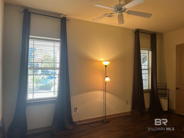 unfurnished bedroom featuring ceiling fan and dark hardwood / wood-style flooring