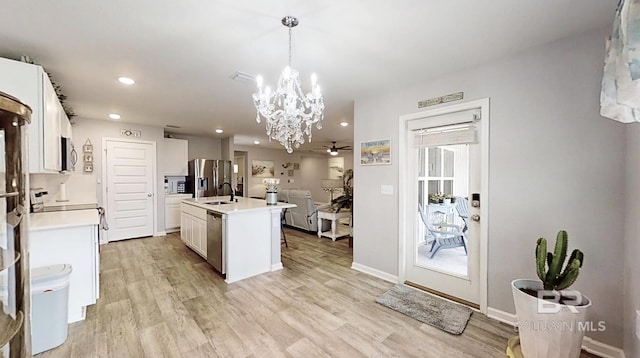 kitchen featuring light wood-style floors, stainless steel appliances, and light countertops