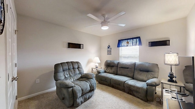 carpeted living room featuring a ceiling fan and baseboards