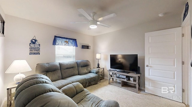 carpeted living room with a ceiling fan