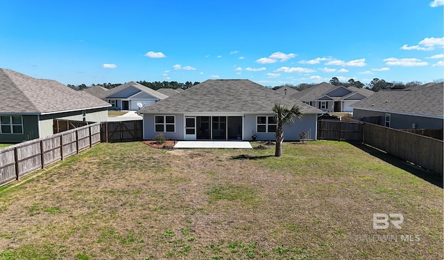 back of property featuring a patio area, a fenced backyard, a shingled roof, and a yard