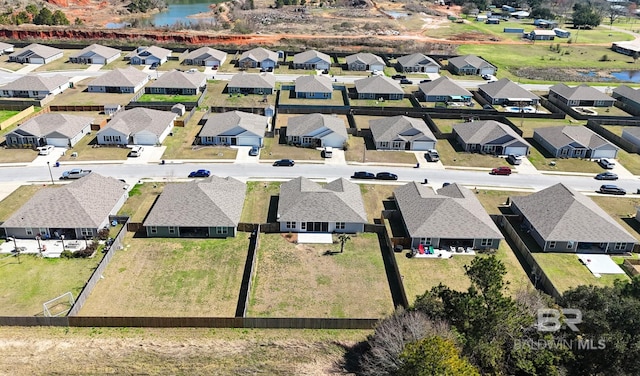 drone / aerial view with a water view and a residential view