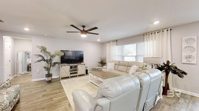 living area featuring baseboards, ceiling fan, light wood-style flooring, and recessed lighting