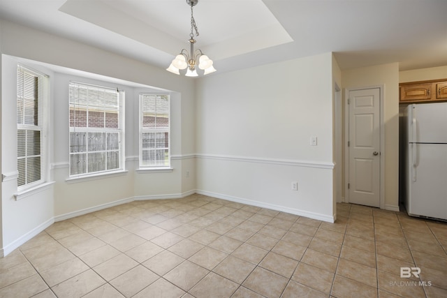 unfurnished dining area featuring a raised ceiling, light tile patterned floors, baseboards, and an inviting chandelier