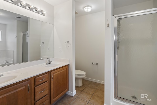 full bathroom featuring double vanity, a stall shower, visible vents, tile patterned floors, and a sink