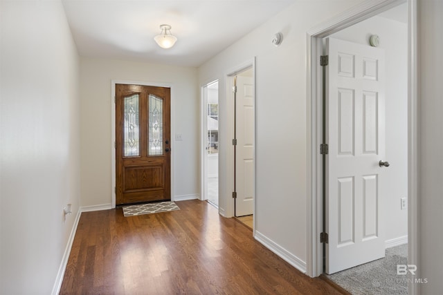 entrance foyer featuring wood finished floors and baseboards