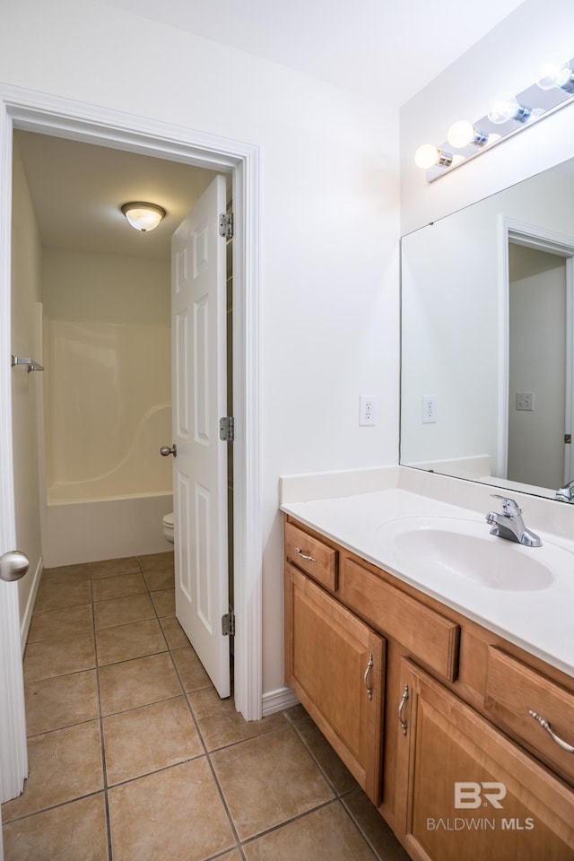 bathroom with  shower combination, tile patterned flooring, and vanity