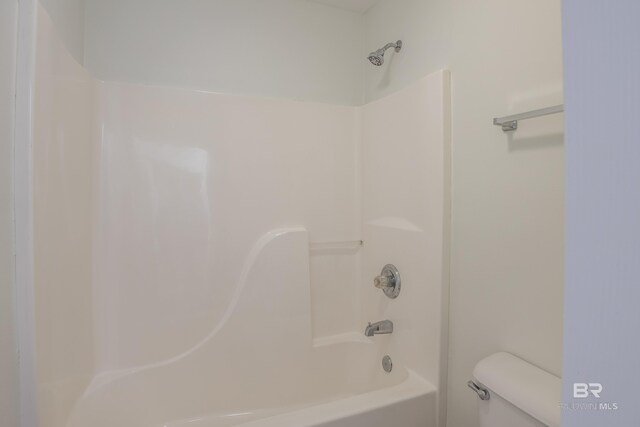 bathroom featuring toilet and tub / shower combination