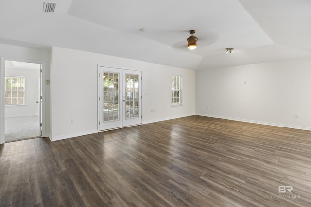 unfurnished room featuring ceiling fan, vaulted ceiling, wood finished floors, and visible vents