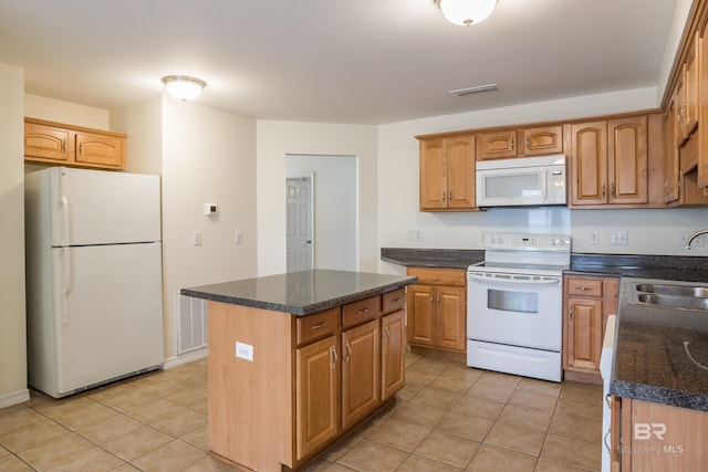 kitchen featuring light tile patterned floors, white appliances, a sink, and visible vents