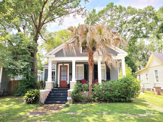 view of front of home with a porch and a front lawn