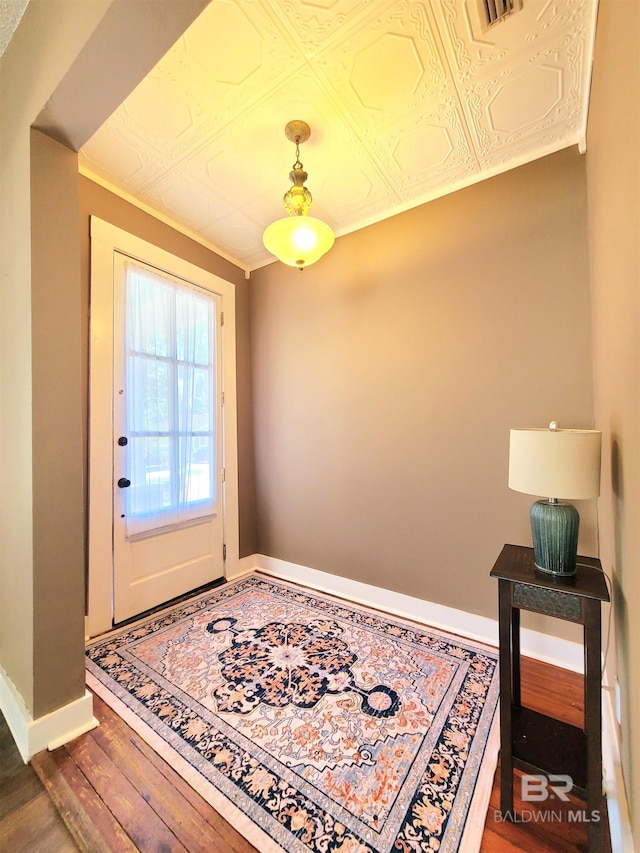 112 Espejo St, Mobile, AL 36604 - entryway with baseboards, visible vents, wood finished floors, and an ornate ceiling