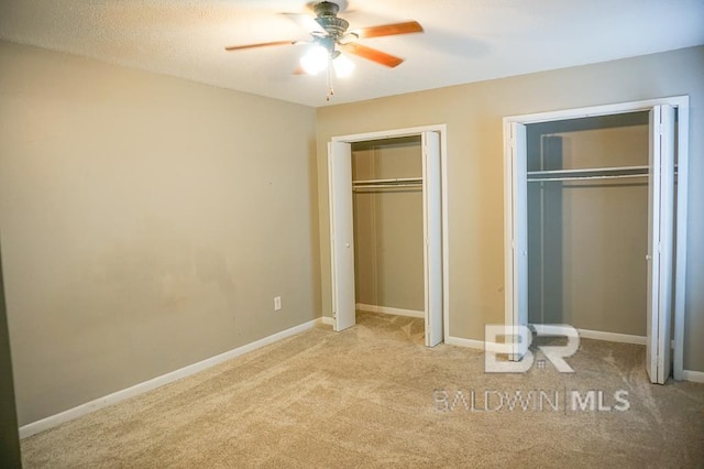 4366 Fathbrook Ln, Mobile, AL 36693 - unfurnished bedroom featuring multiple closets, carpet flooring, a ceiling fan, and baseboards