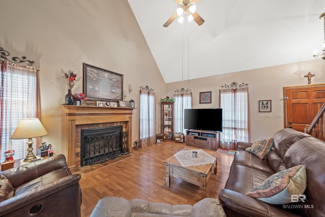 living room featuring ceiling fan, a healthy amount of sunlight, wood-type flooring, and high vaulted ceiling