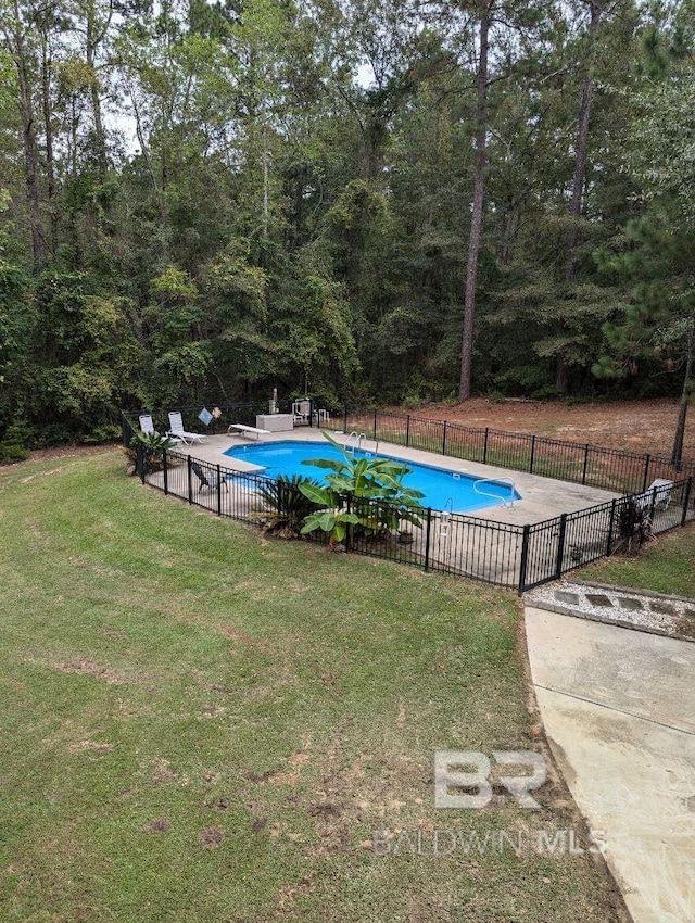 view of pool featuring a diving board, a patio, and a lawn