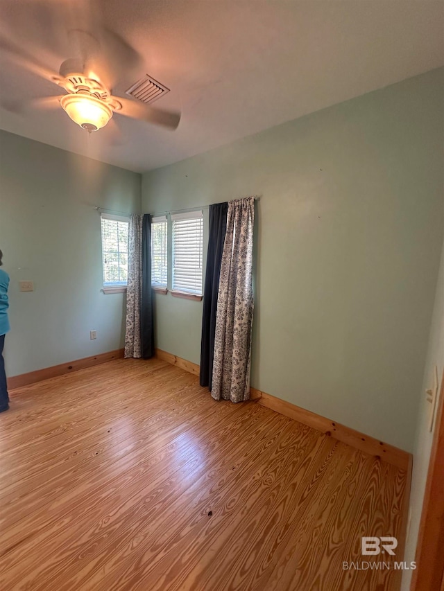 empty room featuring ceiling fan and light hardwood / wood-style floors