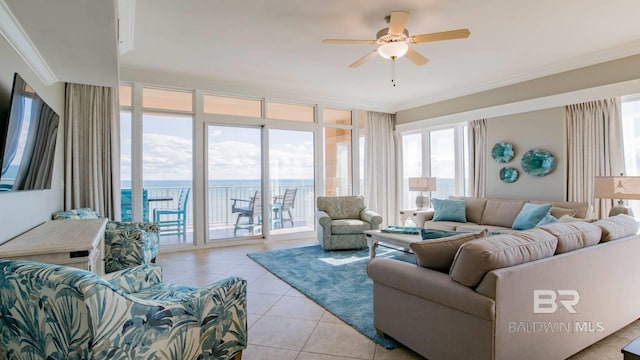 tiled living room featuring ornamental molding, ceiling fan, and a water view