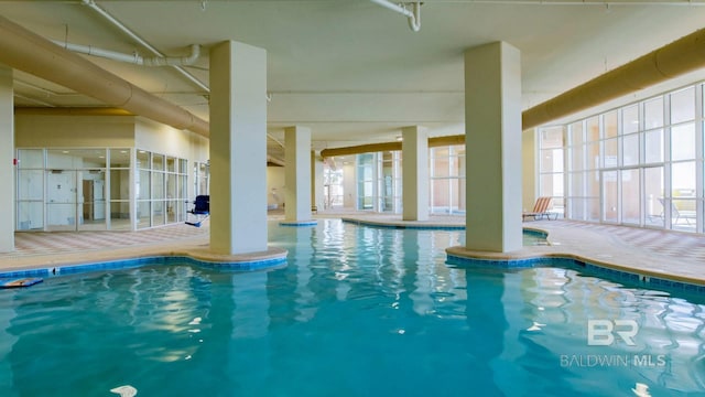 view of pool featuring a patio and glass enclosure