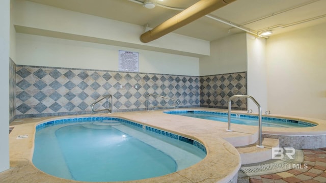 view of pool featuring an indoor hot tub