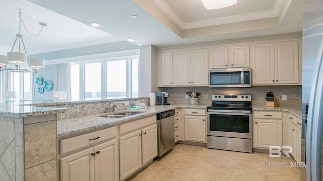 kitchen with hanging light fixtures, appliances with stainless steel finishes, sink, and kitchen peninsula