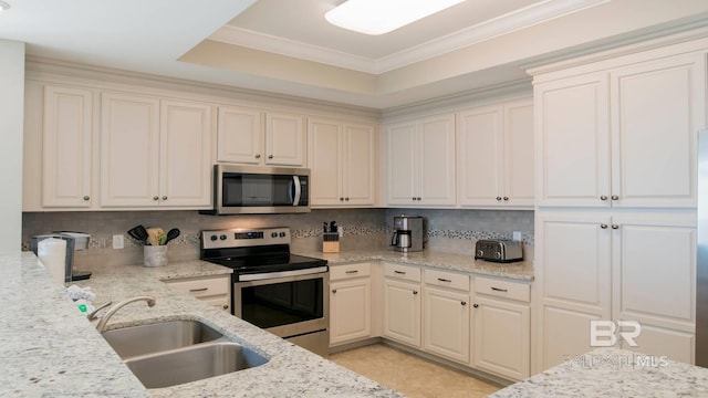 kitchen with sink, crown molding, tasteful backsplash, stainless steel appliances, and light stone countertops