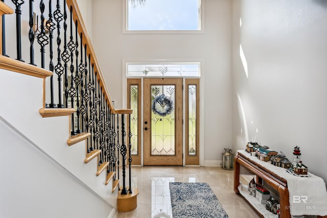 foyer featuring a towering ceiling