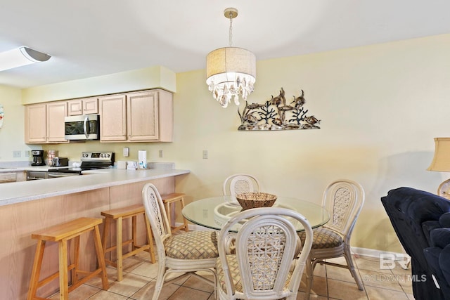 tiled dining space with an inviting chandelier