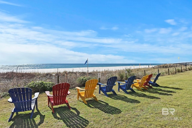 view of yard featuring a view of the beach and a water view