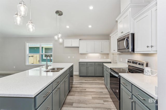 5885 Grotto Ave, Pensacola, FL 32507 - kitchen with appliances with stainless steel finishes, a sink, gray cabinets, white cabinets, and recessed lighting