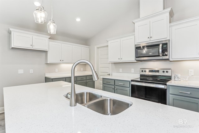 5885 Grotto Ave, Pensacola, FL 32507 - kitchen featuring appliances with stainless steel finishes, a sink, white cabinetry, and lofted ceiling