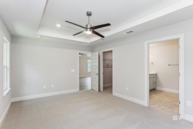 5885 Grotto Ave, Pensacola, FL 32507 - unfurnished bedroom with a tray ceiling, light colored carpet, baseboards, a spacious closet, and a closet