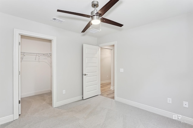 5885 Grotto Ave, Pensacola, FL 32507 - unfurnished bedroom with a walk in closet, carpet, a closet, and baseboards