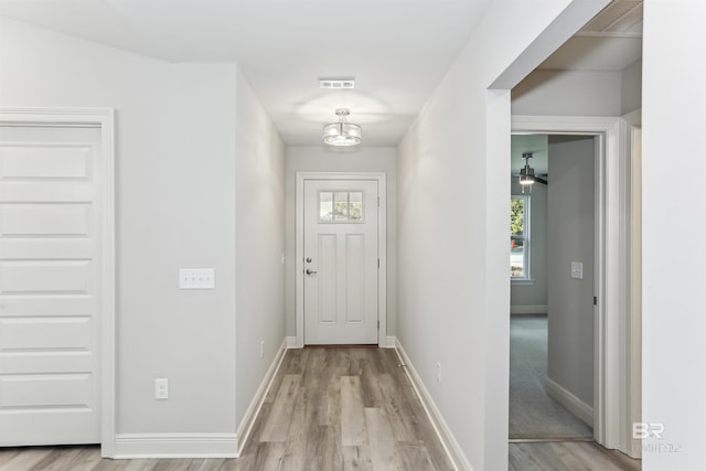 5885 Grotto Ave, Pensacola, FL 32507 - doorway with light wood-style floors, plenty of natural light, baseboards, and a chandelier