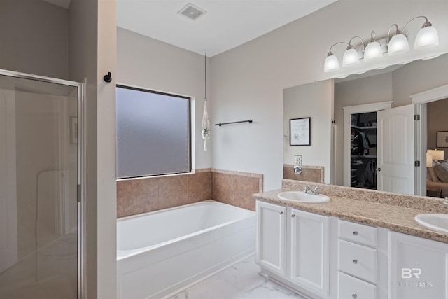 full bathroom with visible vents, a garden tub, a stall shower, marble finish floor, and a sink