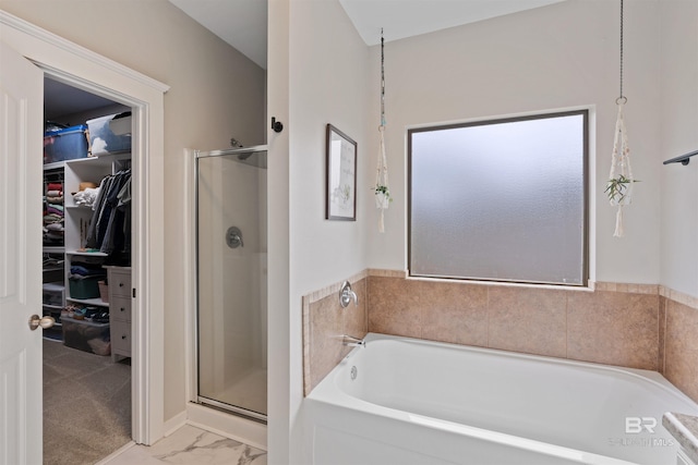 bathroom with a shower stall, a spacious closet, a bath, and marble finish floor