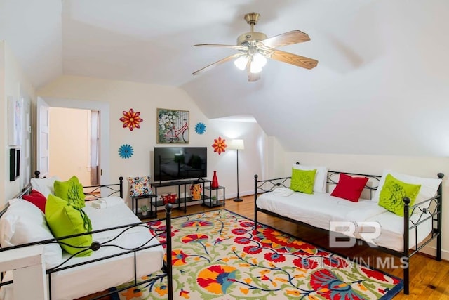 living room with vaulted ceiling, ceiling fan, and wood-type flooring