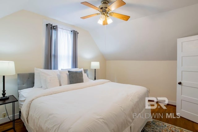 bedroom featuring ceiling fan, vaulted ceiling, and dark wood-type flooring