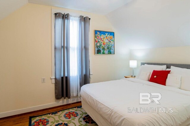 bedroom featuring vaulted ceiling and hardwood / wood-style flooring