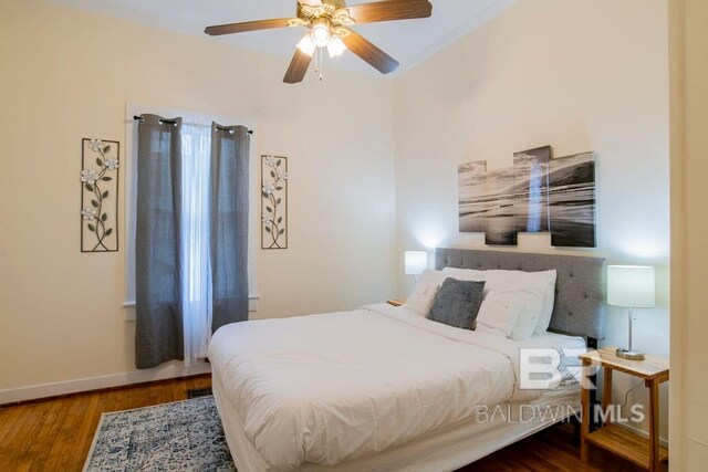 bedroom with wood-type flooring, ceiling fan, and ornamental molding