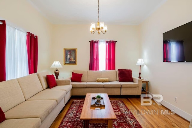 living room featuring hardwood / wood-style flooring and an inviting chandelier