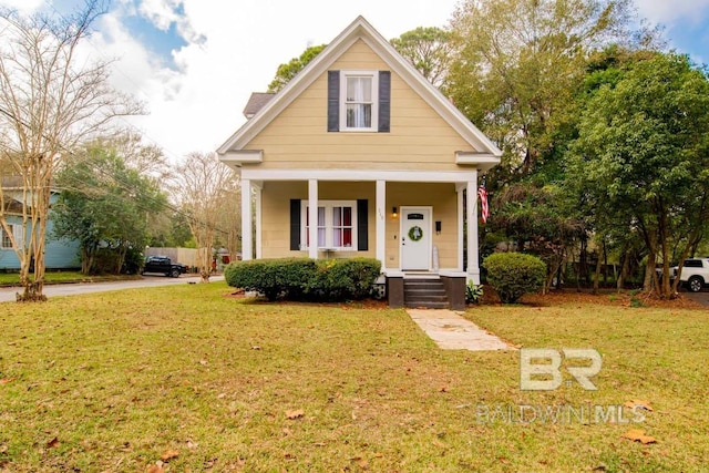 bungalow with covered porch and a front lawn