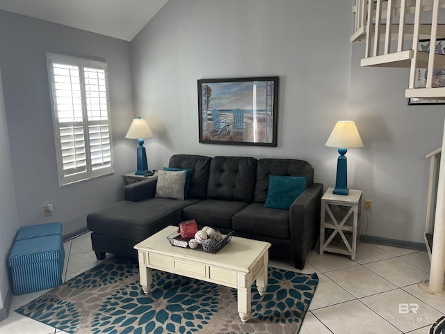 25805 Perdido Beach Blvd Unit 419, Orange Beach, AL 36561 - living room with baseboards, light tile patterned flooring, and lofted ceiling