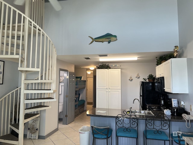 25805 Perdido Beach Blvd Unit 419, Orange Beach, AL 36561 - kitchen featuring a peninsula, light tile patterned floors, black appliances, visible vents, and a sink