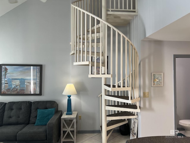25805 Perdido Beach Blvd Unit 419, Orange Beach, AL 36561 - staircase featuring tile patterned floors and a towering ceiling