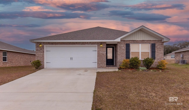 single story home with cooling unit, a garage, and a yard