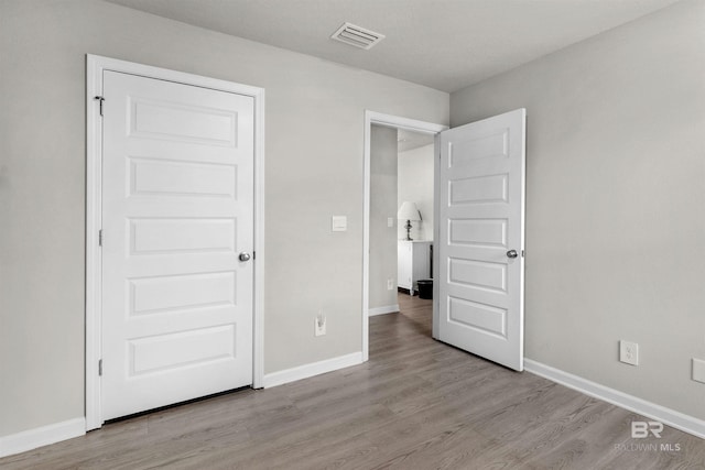 unfurnished bedroom featuring light wood-type flooring